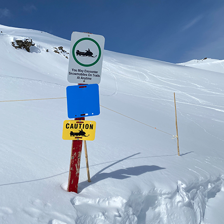 H209 You May Encounter Snowmobiles on Trails at Anytime 18" x 24" White Reflective Aluminum Sign produced by Inter-Mtn.. Click to expand image