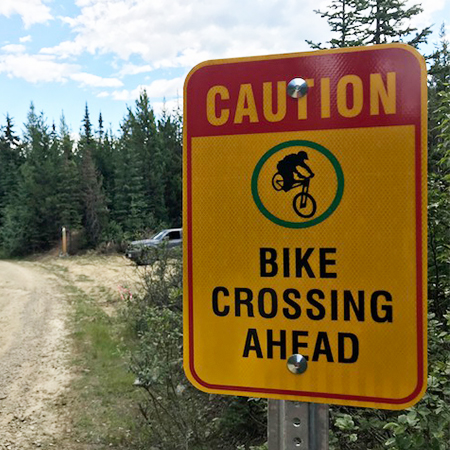 B602, 18 x 24, bike crossing ahead, Mountain bike risk and liability, safety, summer, trail, downhill, available on white or yellow coroplast and 12 gauge sign grade aluminum sheeted with top quality, high performance print* or vinyl graphics.. Click to expand image