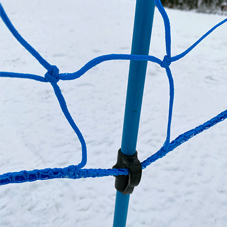 Bright blue pop fence with pole hook on snow.. Click to expand image