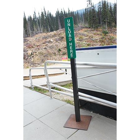 D71 Unload Here - Green Rectangle Disc 4" x 20", polythylene disc, UV protected and cost effective marking signs, holes on top to hang from rope, slots top and bottom to fit over bamboo poles, trail and ability markers.. Click to expand image