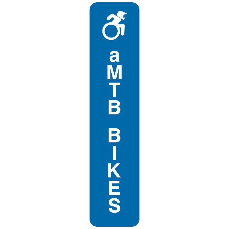 aMTB lift load enterance. Signage for adaptive mountain biking technical trails shows trail designation. The aMTB symbol indicates accessibility for adaptive bikes/riders on adaptive bike-friendly aMTB trails on trail networks.. Click to expand image