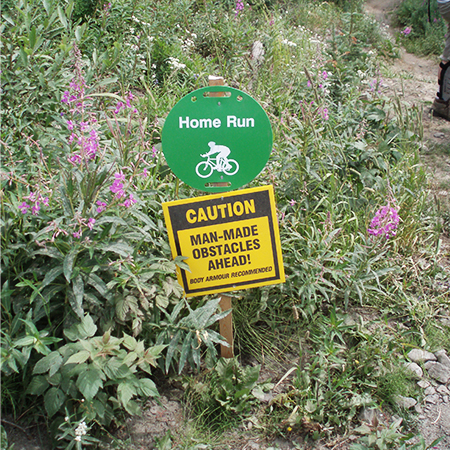 B400, 18 x 18, 12 x 12, caution man-made obstacles ahead, body armour recommended, Mountain bike risk and liability, safety, summer, trail, downhill, available on white or yellow coroplast and 12 gauge sign grade aluminum sheeted with top quality, high performance print* or vinyl graphics.. Click to expand image