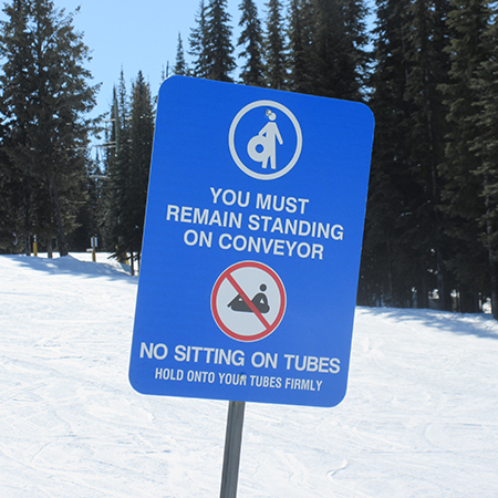 L608 Must Remain Standing on Conveyor, No Sitting on Tubes 18" x 24" Blue Reflective Aluminum lift sign for ski areas - produced by Inter-Mtn.. Click to expand image