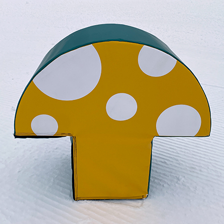 Kid's yellow foam mushroom block on snow.. Click to expand image