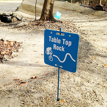 E101, 11.5 x 11.5, mountain bike trail name cross-country, blue square polythylene disc, UV protected and cost effective marking signs, holes on top to hang from rope, slots top and bottom to fit over bamboo poles, trail and ability markers.. Click to expand image
