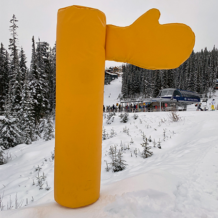 Ski Around Bumper with Hand yellow on snow.. Click to expand image