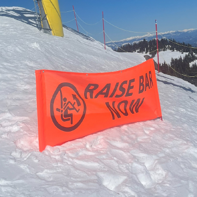 BH49 Raise Bar Now. High-visibility orange banner at the top of Sun Peaks Resort's chairlift in British Columbia. Click to expand image