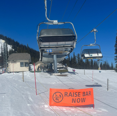 BH49 Raise Bar Now. High-visibility orange banner at the top of Sun Peaks Resort's chairlift in British Columbia. Click to expand image