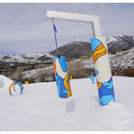 Punching Bag - Aluminum Square Stand at Sun Valley on Dollar Mountain. This custom punching bag on a 10 foot aluminum stand is seen on the snow. At Sun Valley Resort, they partnered with local artist Kika Macfarlane to create a unique, energetic collection of Kidstuff pieces.