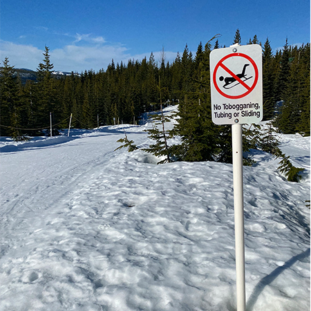 H117 No Tobogganing, Tubing or Sliding 18" x 24" White Reflective Aluminum Sign produced by Inter-Mtn.. Click to expand image