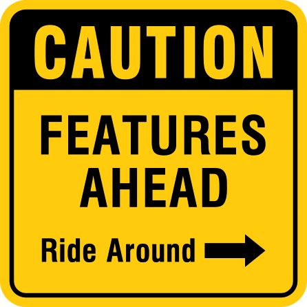 Mountain bike risk and liability signage: caution features ahead. Click to expand image
