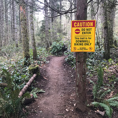 B610, 18 x 24, caution do not enter, trail is for downhill biking only, no hiking, no uphill biking, Mountain bike risk and liability, safety, summer, trail, downhill, available on white or yellow coroplast and 12 gauge sign grade aluminum sheeted with top quality, high performance print* or vinyl graphics.. Click to expand image