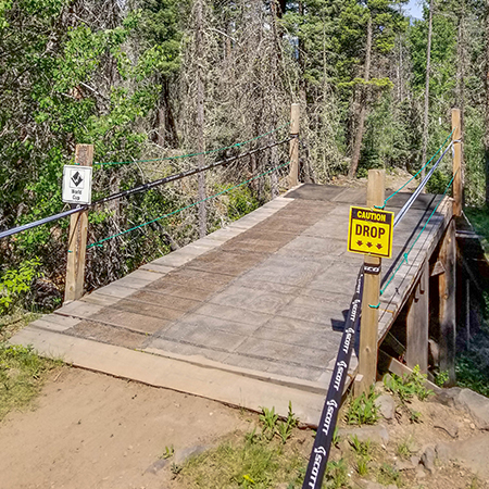 B412, 18 x 18, 12 x 12, caution drop, arrows pointing down, Mountain bike risk and liability, safety, summer, trail, downhill, available on white or yellow coroplast and 12 gauge sign grade aluminum sheeted with top quality, high performance print* or vinyl graphics.. Click to expand image