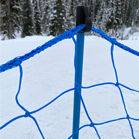 Bright blue pop fence with pole hook on snow.. Click to expand image