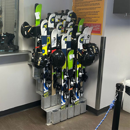 Ski Rack for interior use in rentals and retail shops. This aluminum ski and snowboard rack is seen in a boot rental shop at a Quebec Ski Resort